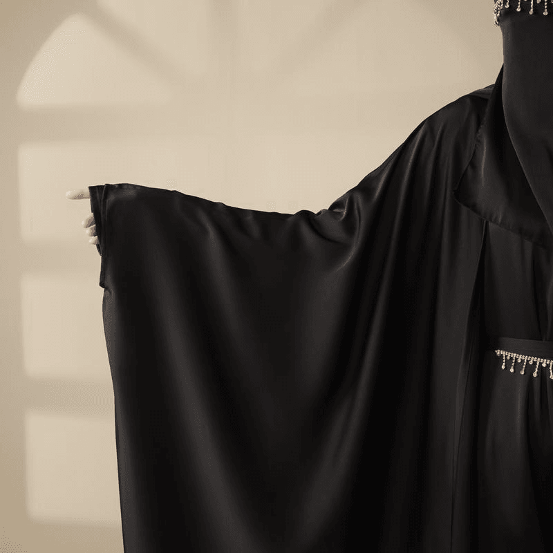 Black 5 piece satin abaya set by Fabaya UK with flowing sleeves and beaded details