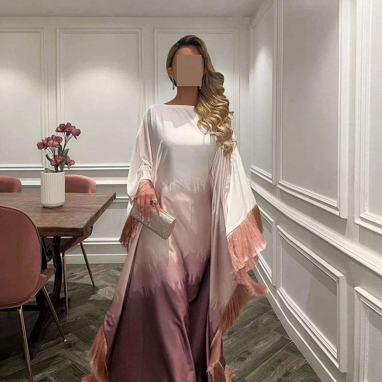 Elegant woman wearing a gradient modest dress with fringed sleeves in a stylish room shop modest fashion UK