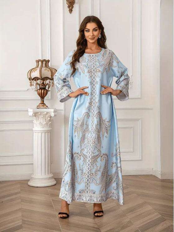 Elegant kaftans for summer in stunning floral prints worn by model in stylish indoor setting