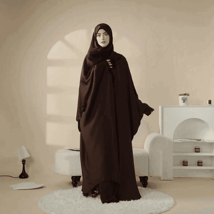 Elegant black 5 piece satin abaya set by Fabaya UK modeled indoors with stylish draping