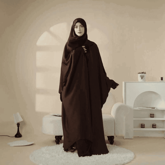 Elegant black 5 piece satin abaya set by Fabaya UK modeled indoors with stylish draping