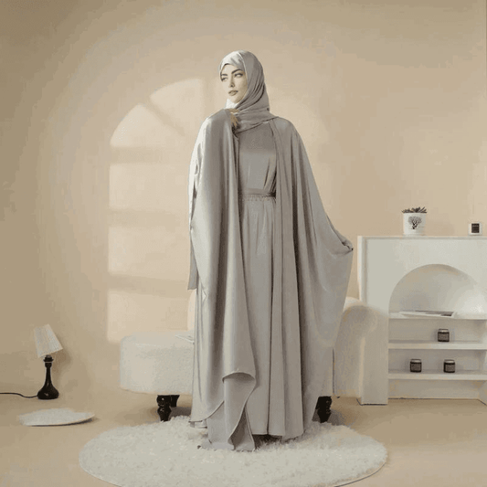 Fabaya UK 5 piece satin abaya set in soft grey worn by woman in elegant modern room