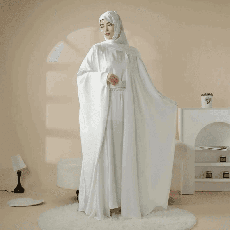 Elegant white 5 piece satin abaya set by Fabaya UK worn by woman with matching headscarf