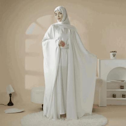 Elegant white 5 piece satin abaya set by Fabaya UK worn by woman with matching headscarf