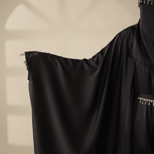 Black 5 piece satin abaya set by Fabaya UK with flowing sleeves and beaded details