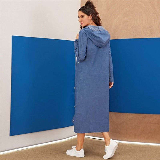 Back view of a woman wearing a blue denim hoodie dress for women paired with white sneakers