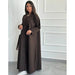 Woman wearing a brown abaya jacket for women by Fabaya UK with long sleeves and button details