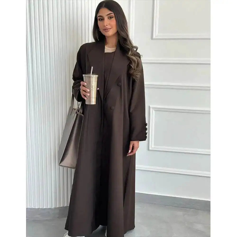 Woman wearing a brown abaya jacket for women by Fabaya UK holding a cup and a handbag