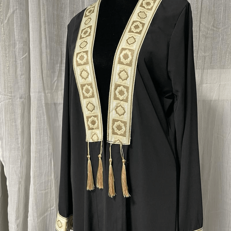 Elegant black chiffon abaya dress for women with gold embroidered trim and tassel details