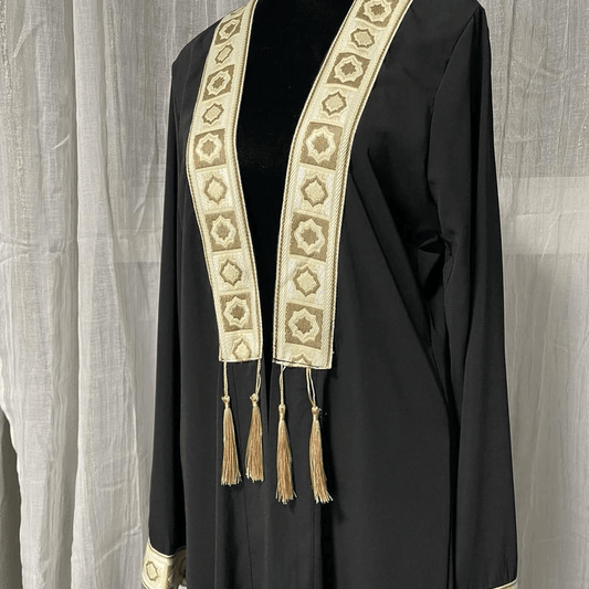 Elegant black chiffon abaya dress for women with gold embroidered trim and tassel details