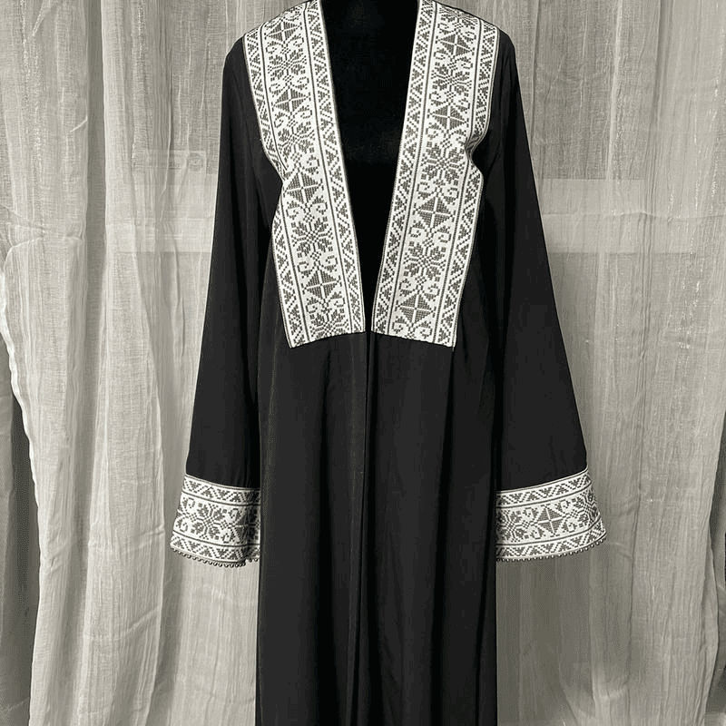 Black chiffon abaya dress for women with white intricate embroidery on front and sleeve cuffs