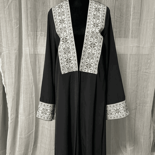 Black chiffon abaya dress for women with white intricate embroidery on front and sleeve cuffs