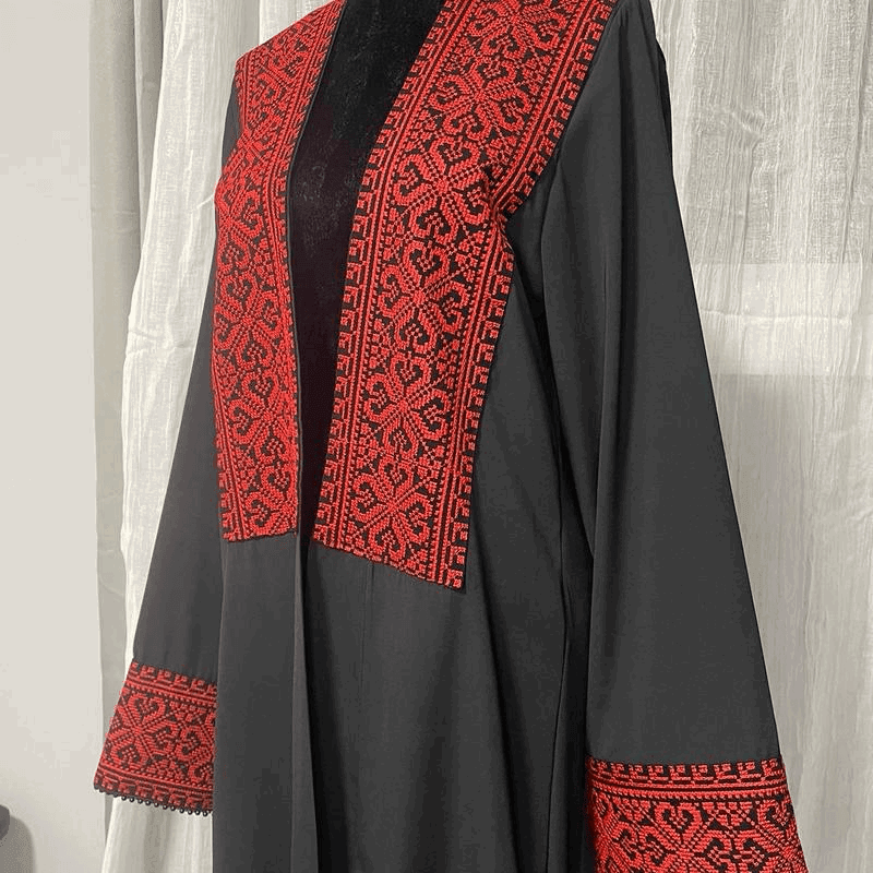 Black chiffon abaya dress for women with intricate red embroidered patterns on front and cuffs