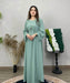Woman wearing a modest mint green cotton linen abaya set with long sleeves and a relaxed fit