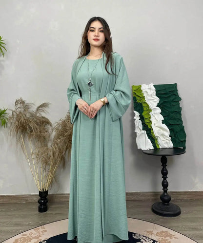 Woman wearing a modest mint green cotton linen abaya set with long sleeves and a relaxed fit