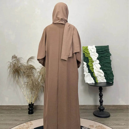 Back view of a brown cotton linen abaya set with matching hijab from Fabaya UK displayed indoors
