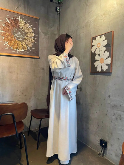 Fabaya UK cotton linen modest dress with floral embroidery on cuffs and waist, worn with a brown hijab