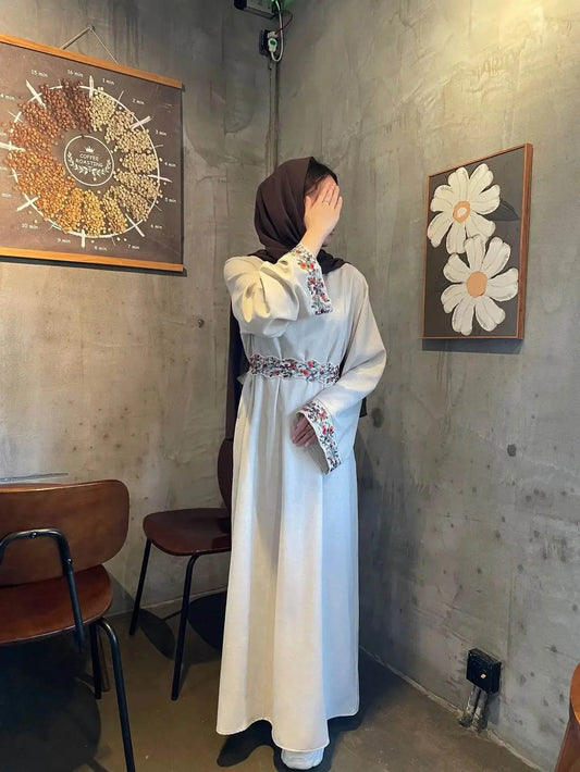 Fabaya UK cotton linen modest dress with floral embroidery on cuffs and waist, worn with a brown hijab