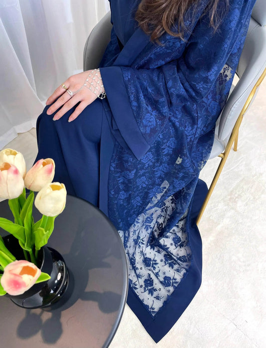 Fabaya UK elegant navy blue lace abaya set with floral patterns worn by a seated woman