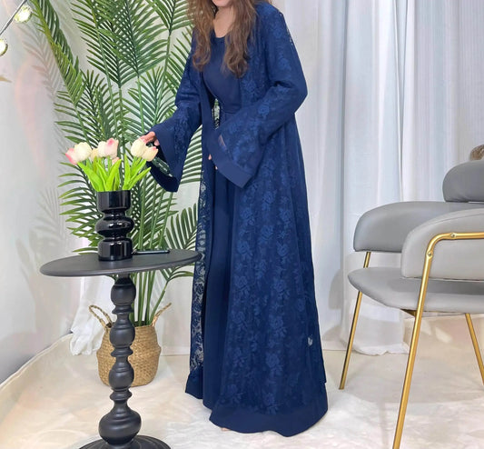 Fabaya UK navy blue lace abaya set with floral pattern worn by woman near black table and flowers