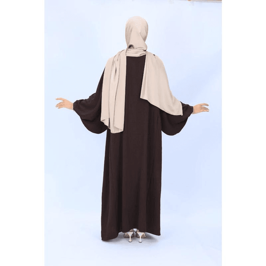 Back view of modest reversible dress for women in dark brown with long sleeves paired with beige hijab