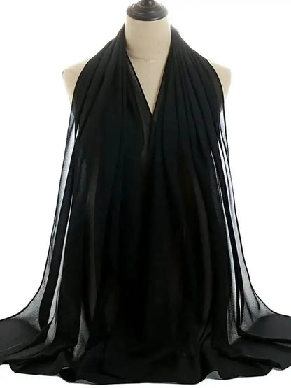 Black shiny silky abaya set draped on a mannequin showcasing smooth fabric and elegant design
