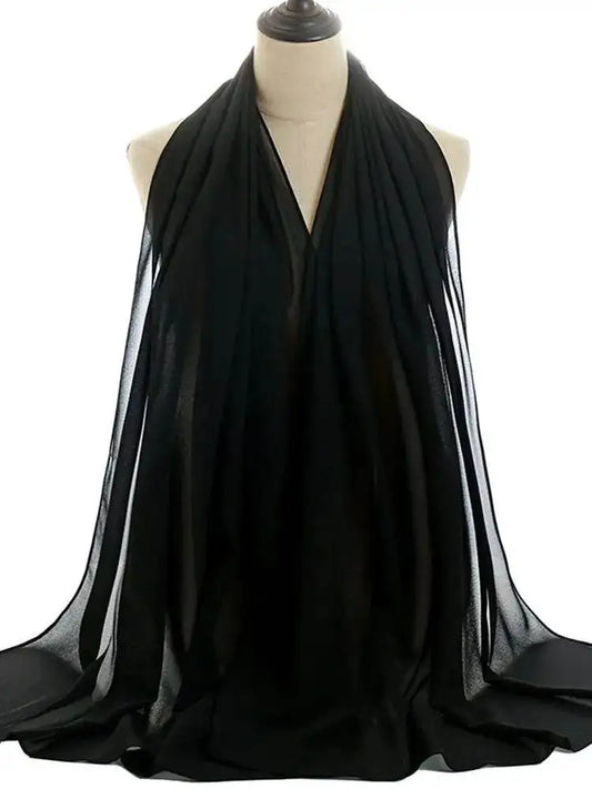 Black shiny silky abaya set draped on a mannequin showcasing smooth fabric and elegant design