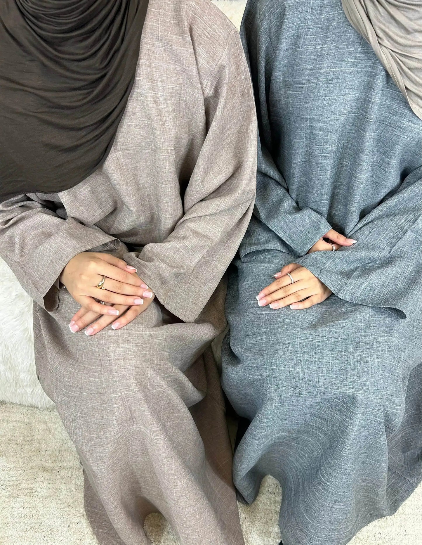 Fabaya UK luxury cotton linen abaya dress in beige and blue worn by seated women with matching hijabs