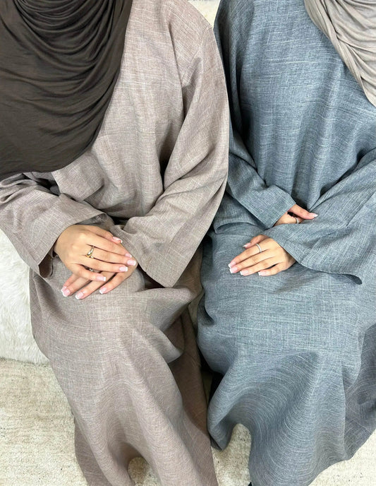 Fabaya UK luxury cotton linen abaya dress in beige and blue worn by seated women with matching hijabs