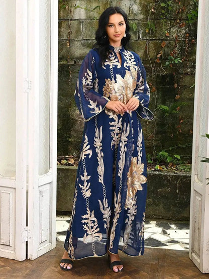 Woman wearing a navy blue Moroccan embroidered abaya dress with gold floral patterns and wide sleeves