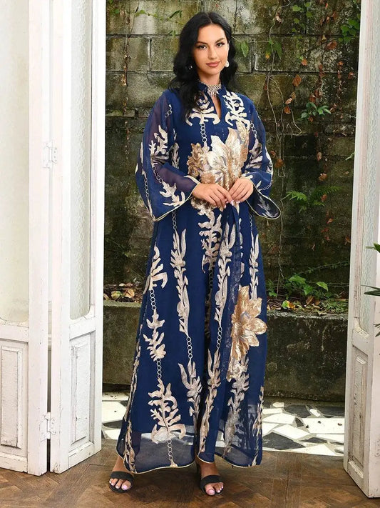 Woman wearing a navy blue Moroccan embroidered abaya dress with gold floral patterns and wide sleeves