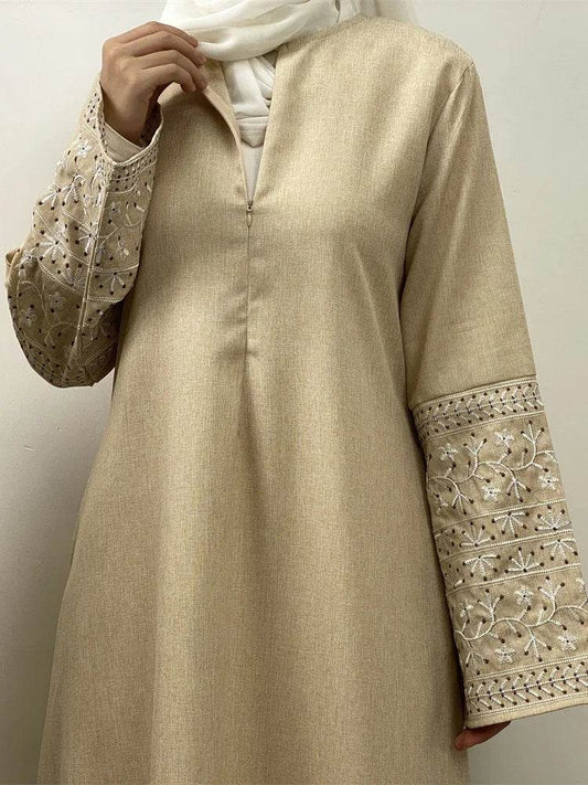 Stylish muslim abaya for women in beige with embroidered floral sleeves and front zipper