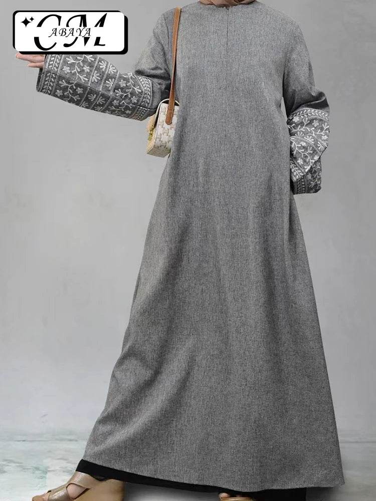 Stylish muslim abaya for women in grey with embroidered wide sleeves and a modest design