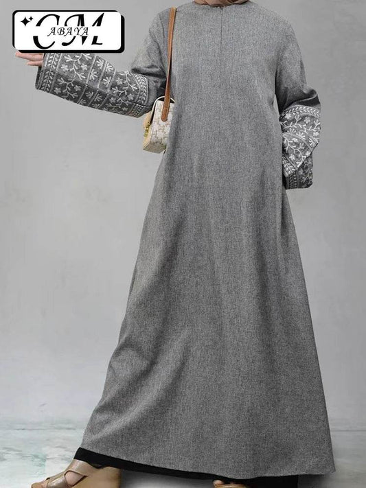 Stylish muslim abaya for women in grey with embroidered wide sleeves and a modest design
